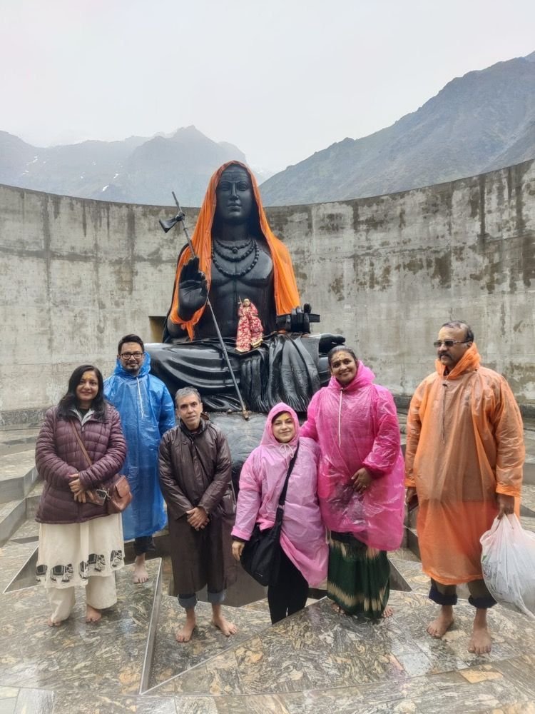Saffron Chariot guests at the Adi Shankaracharya statue behind Kedarnath